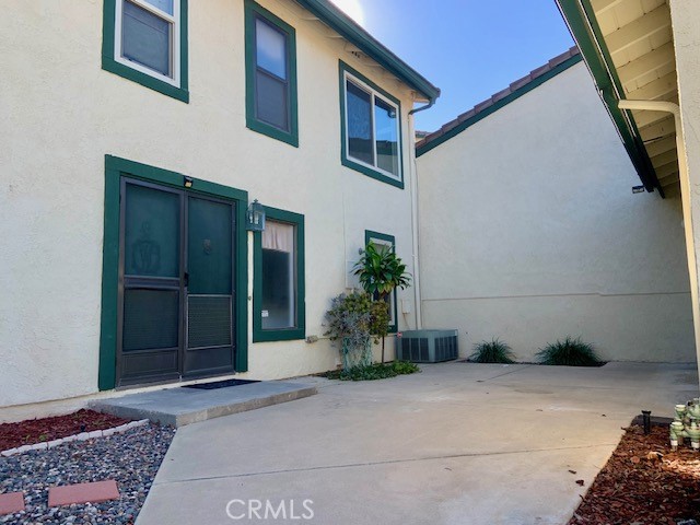 2641 Condor Circle Corona, CA 92882 - Photo 12 of 43 a house with potted plants in front of door