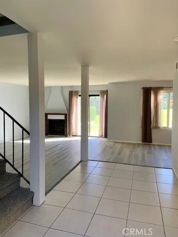 a view of hallway with stairs and wooden floor