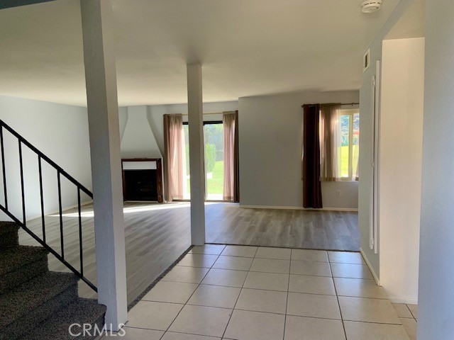 2641 Condor Circle Corona, CA 92882 - Photo 14 of 43 a view of hallway with stairs and wooden floor
