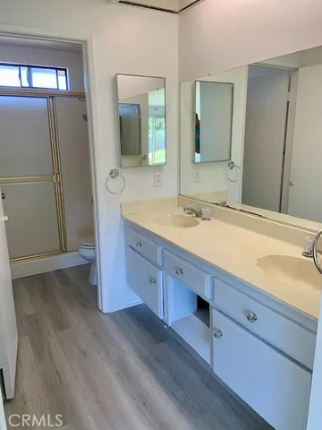 a bathroom with a double vanity sink and mirror