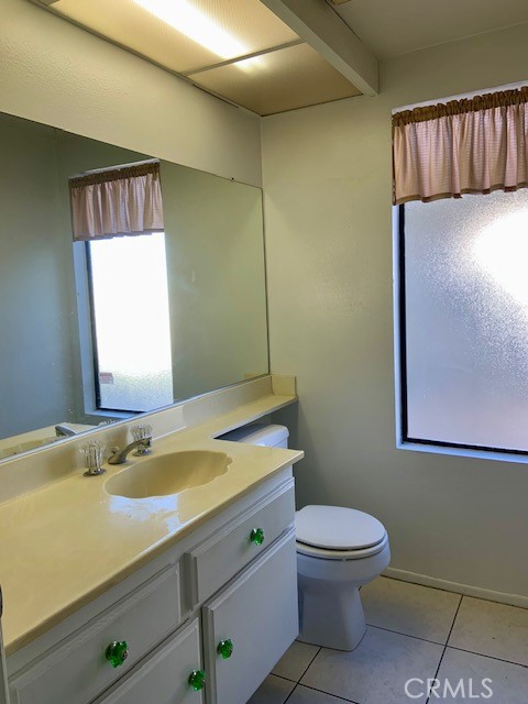 2641 Condor Circle Corona, CA 92882 - Photo 28 of 43 a bathroom with a granite countertop toilet sink and mirror