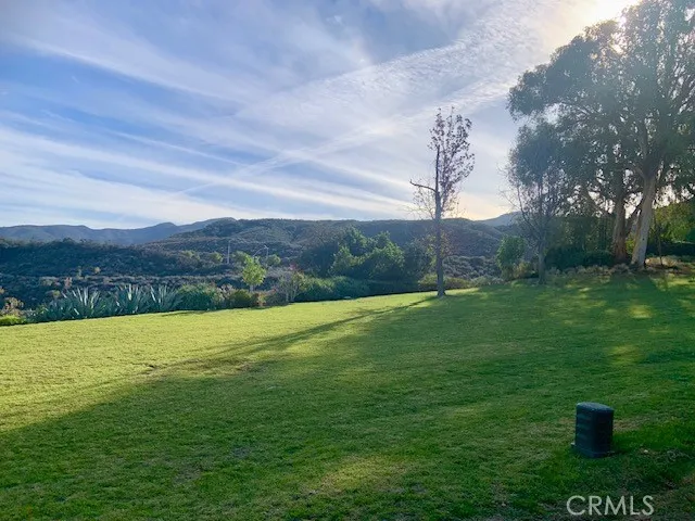 a view of a green field with clear sky