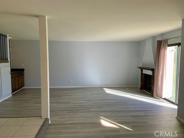 2641 Condor Circle Corona, CA 92882 - Photo 35 of 43 a view of an empty room with wooden floor and a kitchen