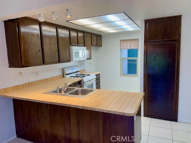 a kitchen with a sink a refrigerator and cabinets