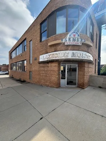 a front view of a building with parking