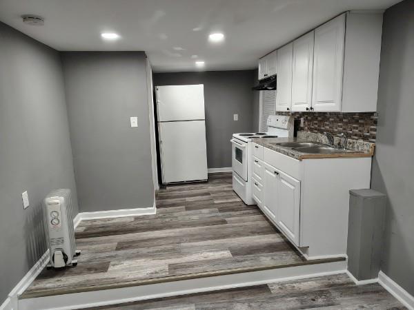 1113 35th Street Columbus, GA 31904 - Photo 3 of 9 a kitchen with kitchen island white cabinets appliances and cabinets