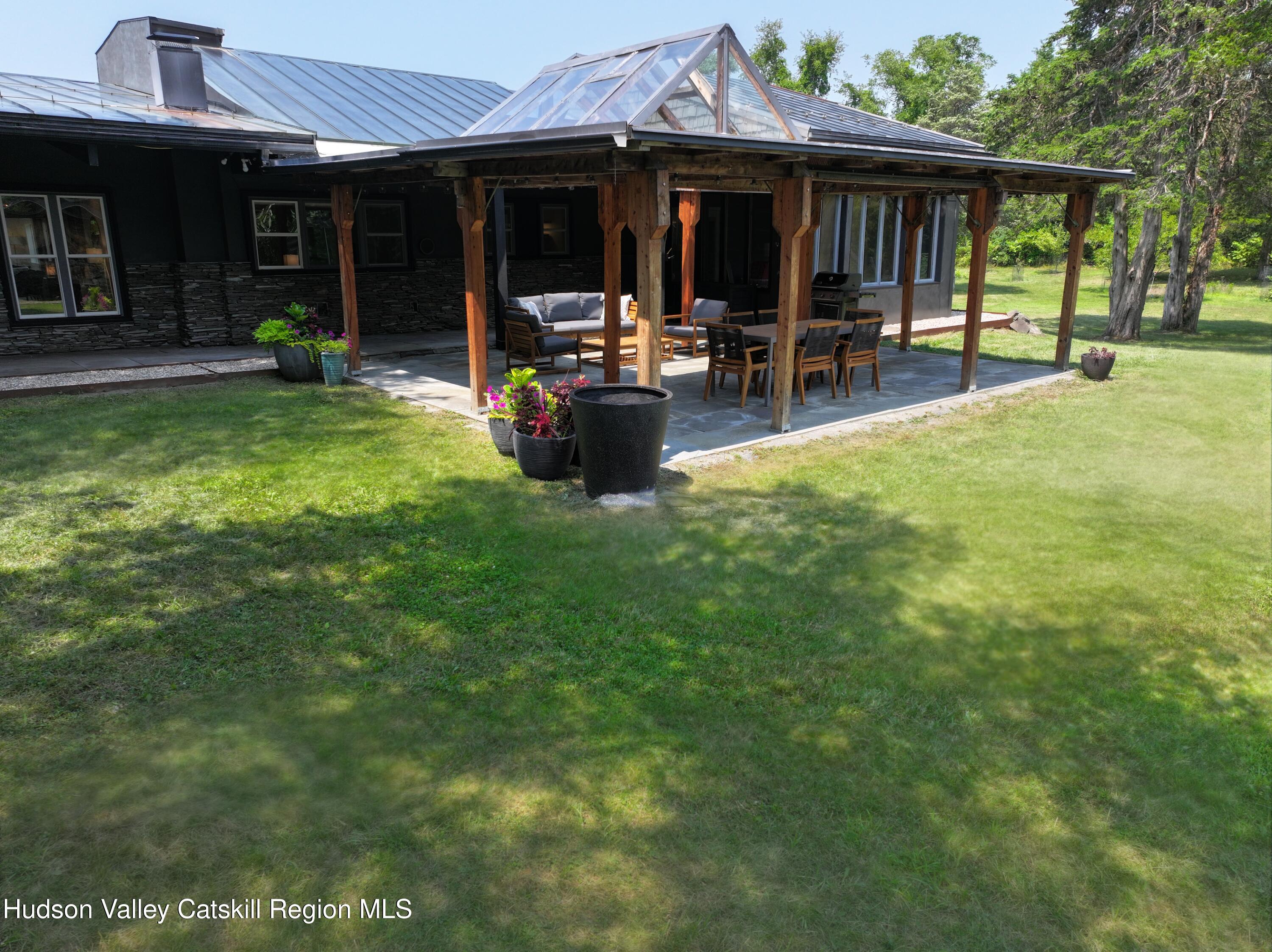 a view of a house with a yard and sitting area