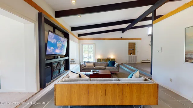 a living room with furniture and floor to ceiling windows