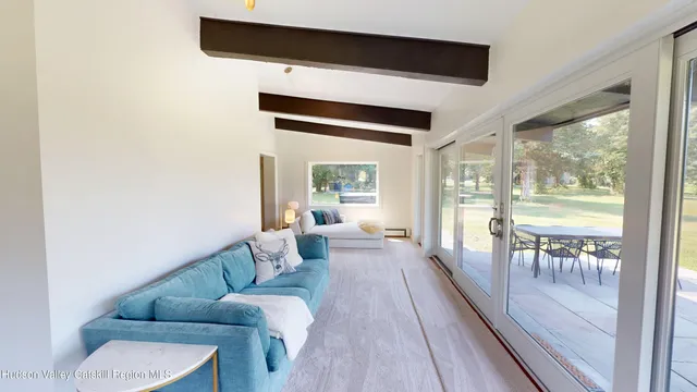 a view of a hallway with a yellow room