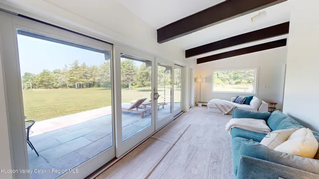 a bedroom with a bed and flat tv screen on the dresser