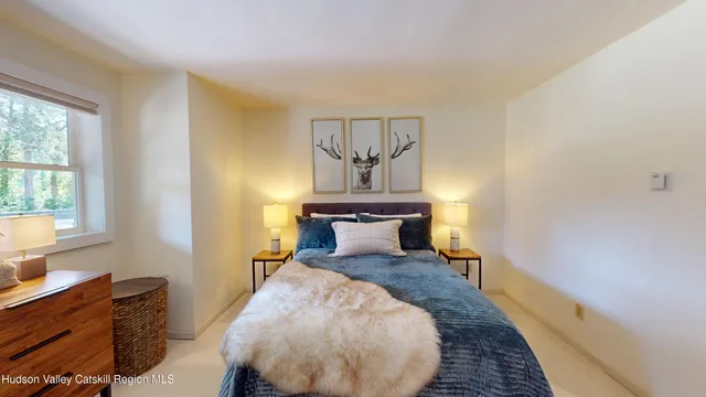 a bedroom with a bed and a window