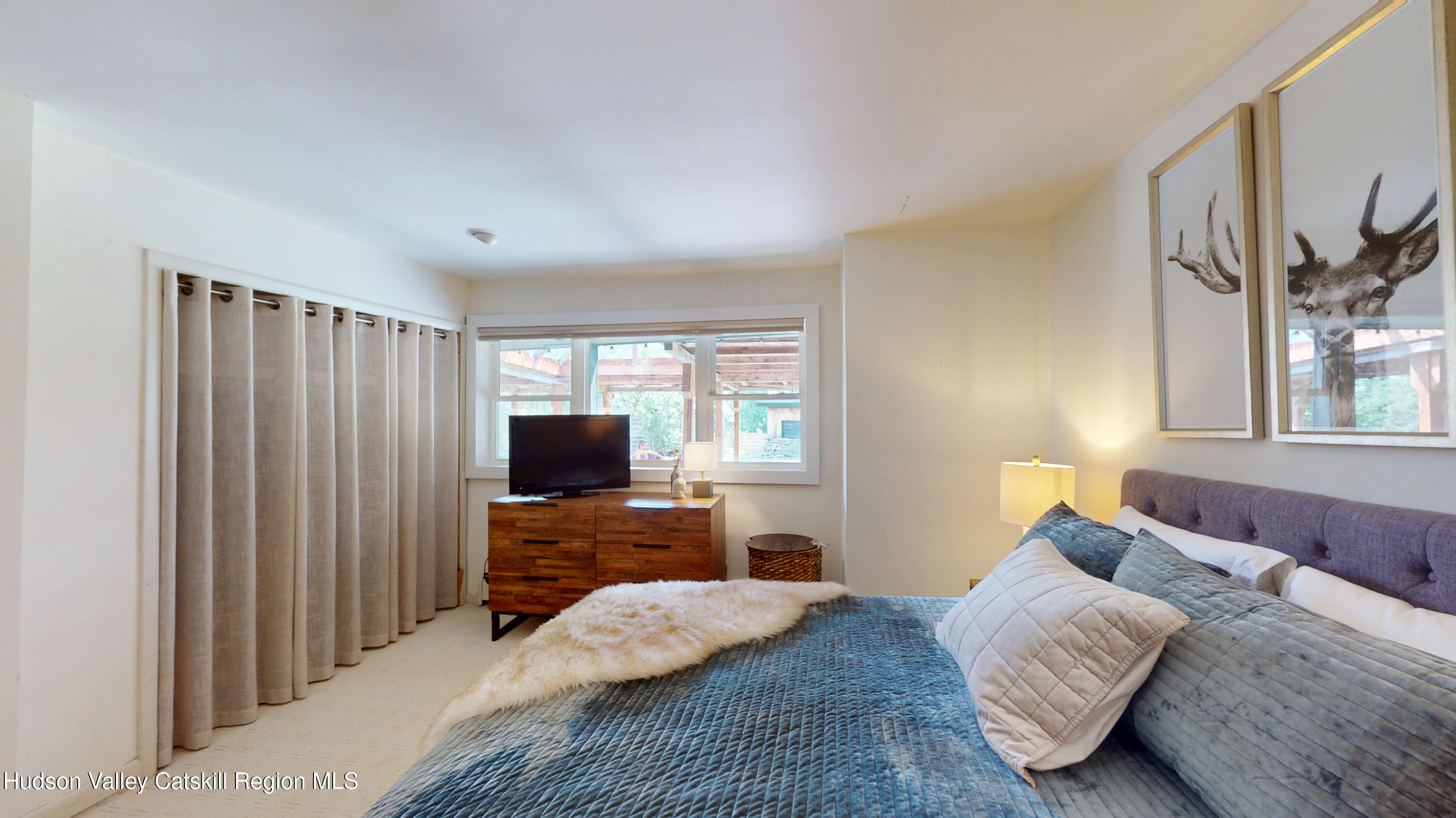 16 Spring Road Hudson, NY 12534 - Photo 20 of 64 a bedroom with a bed and flat tv screen on the dresser