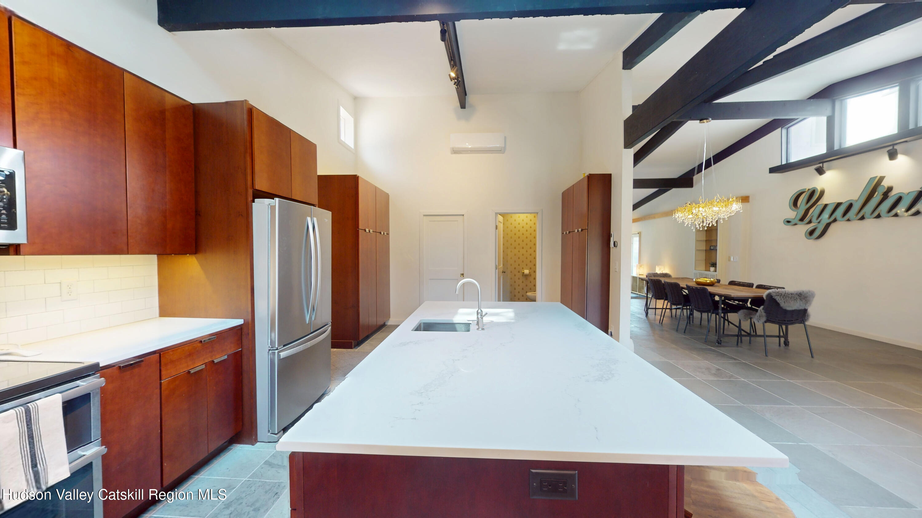 16 Spring Road Hudson, NY 12534 - Photo 4 of 64 a kitchen with stainless steel appliances a dining table chairs and a refrigerator