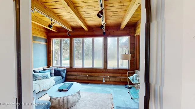 a living room filled with furniture and a floor to ceiling window