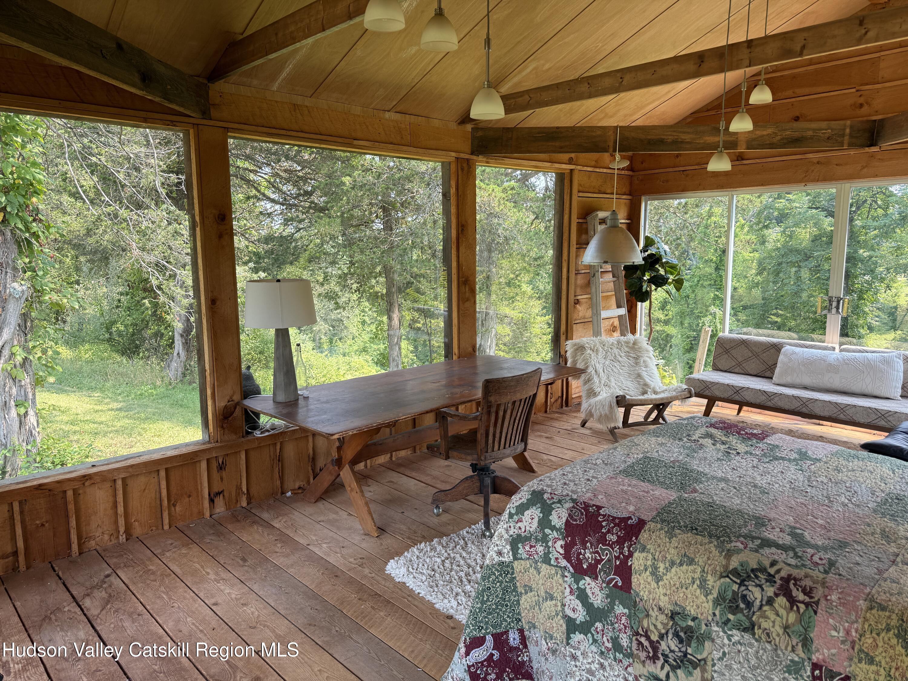 16 Spring Road Hudson, NY 12534 - Photo 49 of 64 a living room with patio furniture and a floor to ceiling window