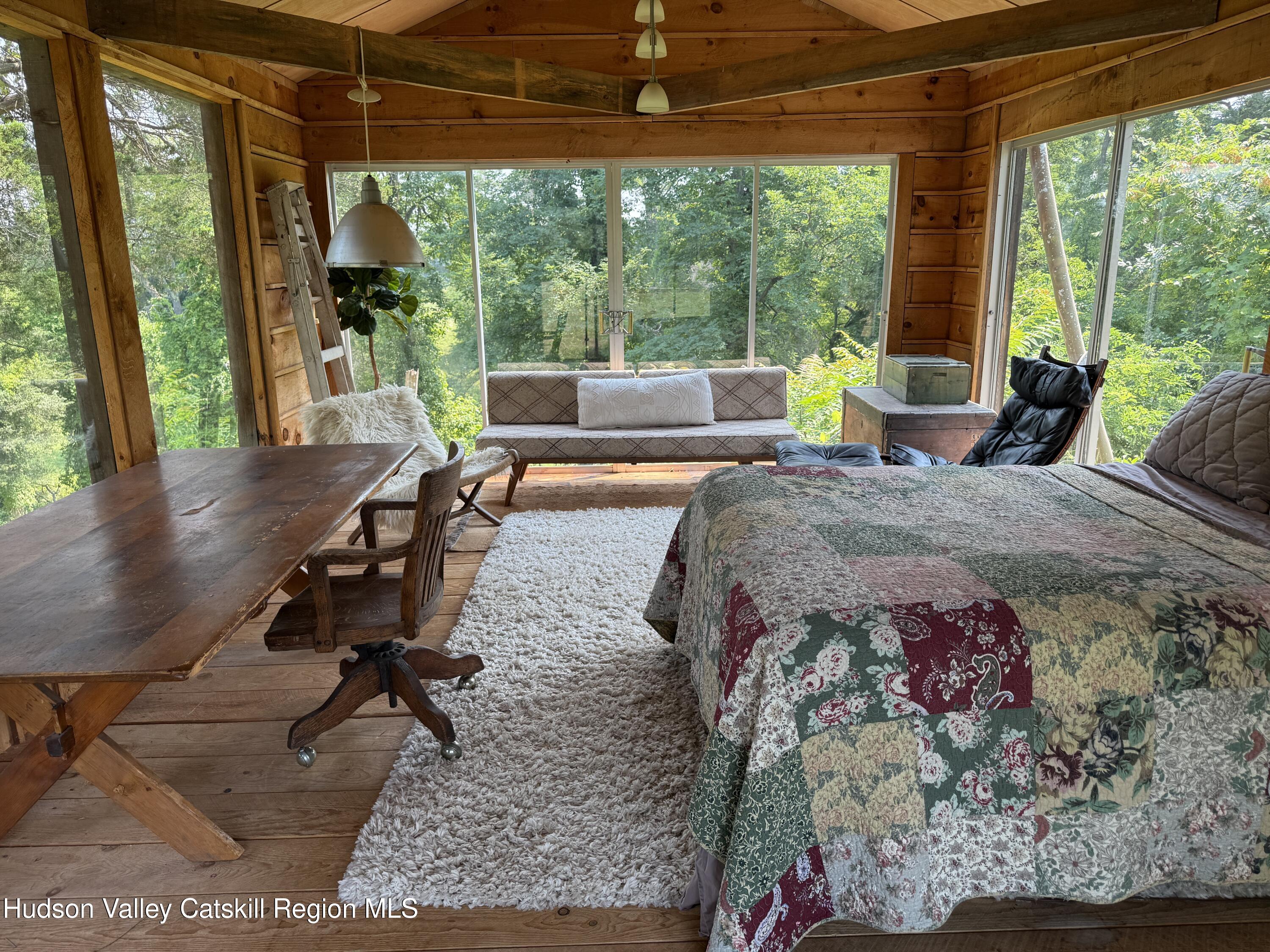 16 Spring Road Hudson, NY 12534 - Photo 50 of 64 a living room filled with furniture and a floor to ceiling window