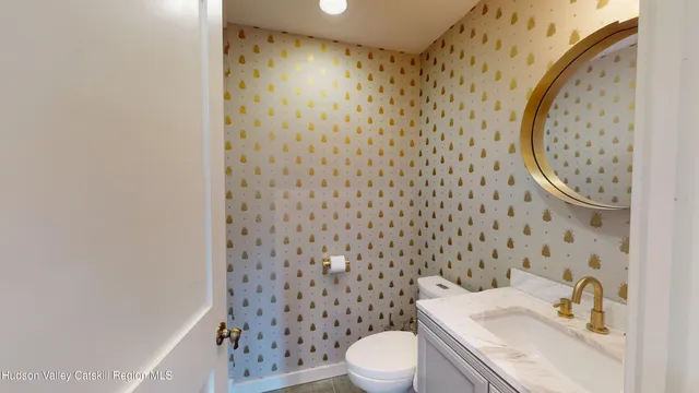 a white toilet sitting next to a bathroom sink