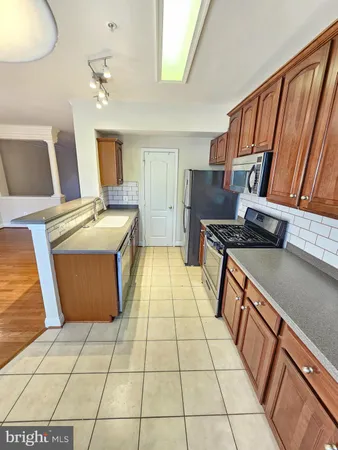 a kitchen with stainless steel appliances a stove a sink and a microwave