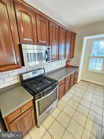 a kitchen with granite countertop a stove and a sink