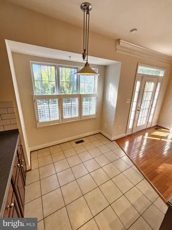 a view of an entryway with a floor to ceiling window and wooden floor