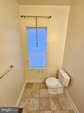 a bathroom with a toilet and shower