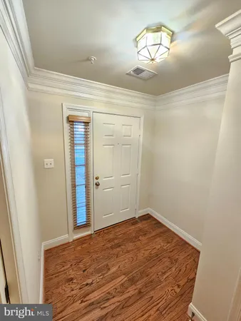 a view of a room with wooden floor