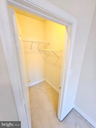 a view of a room with wooden floor and door