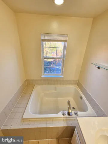 a bathroom with a granite countertop toilet and a shower