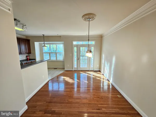 a view of an entryway with wooden floor and a livingroom view