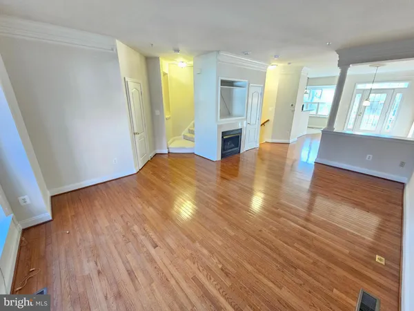 wooden floor in an empty room with a window