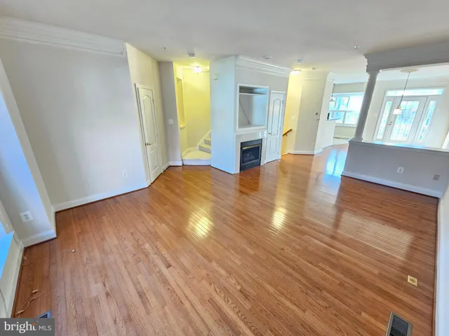 wooden floor in an empty room with a window