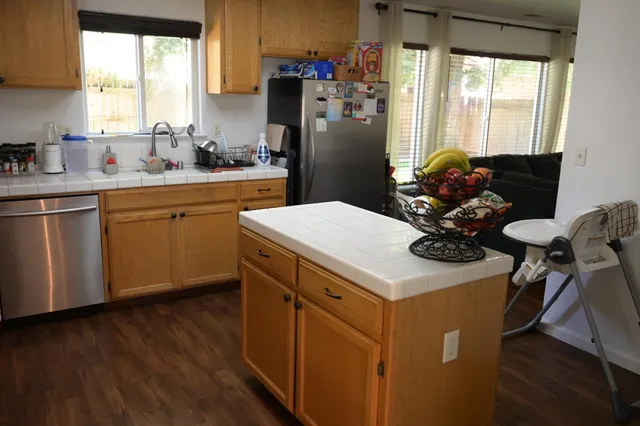 a kitchen with a sink appliances and cabinets