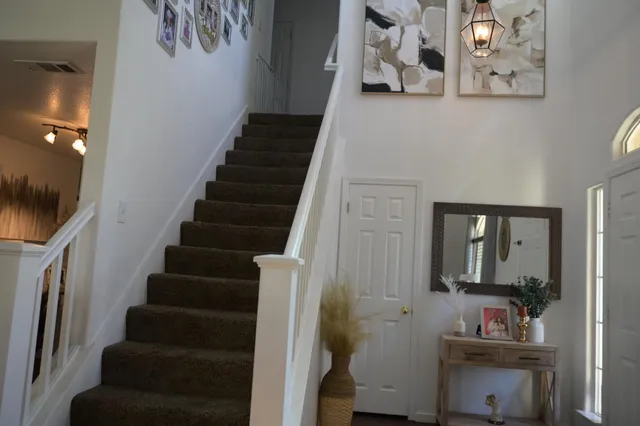 a view of entryway and hall with wooden floor
