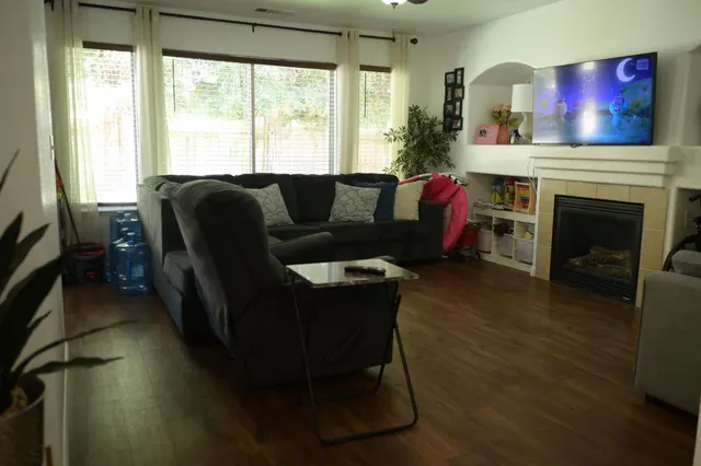 a living room with furniture and a fireplace