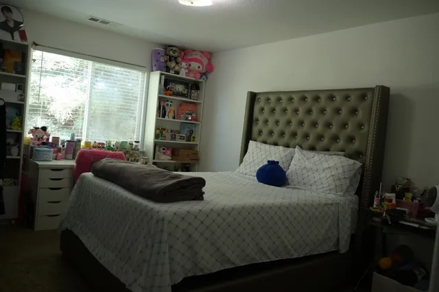 a bedroom with a bed and a window