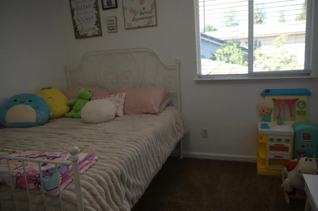 a bedroom with a bed and a window