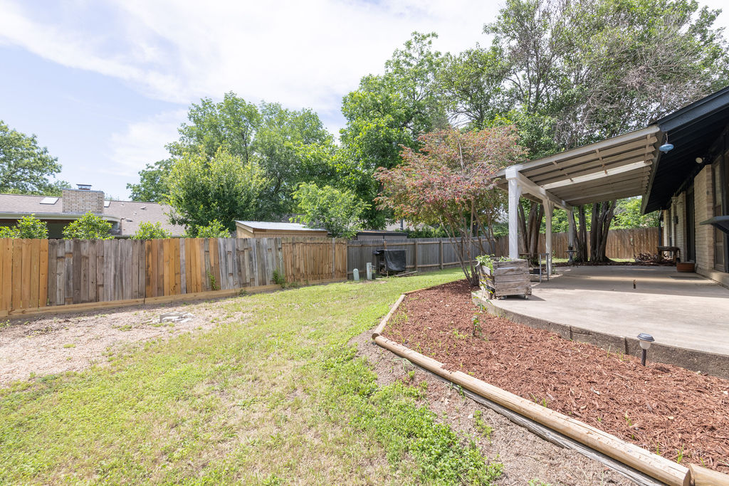 5310 Presidio Road Austin, TX 78745 - Photo 33 of 34 A spacious backyard with mature trees and a shaded patio offers ample room for outdoor enjoyment.