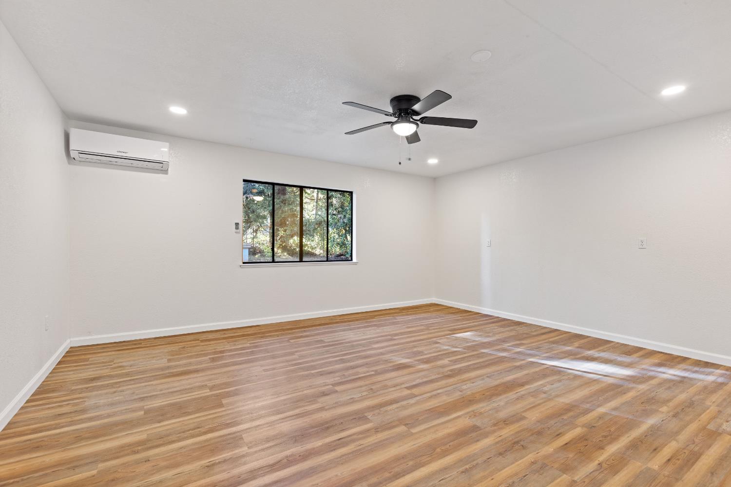 13139 North Meadow View Drive Grass Valley, CA 95945 - Photo 43 of 68 a view of empty room with wooden floor and fan
