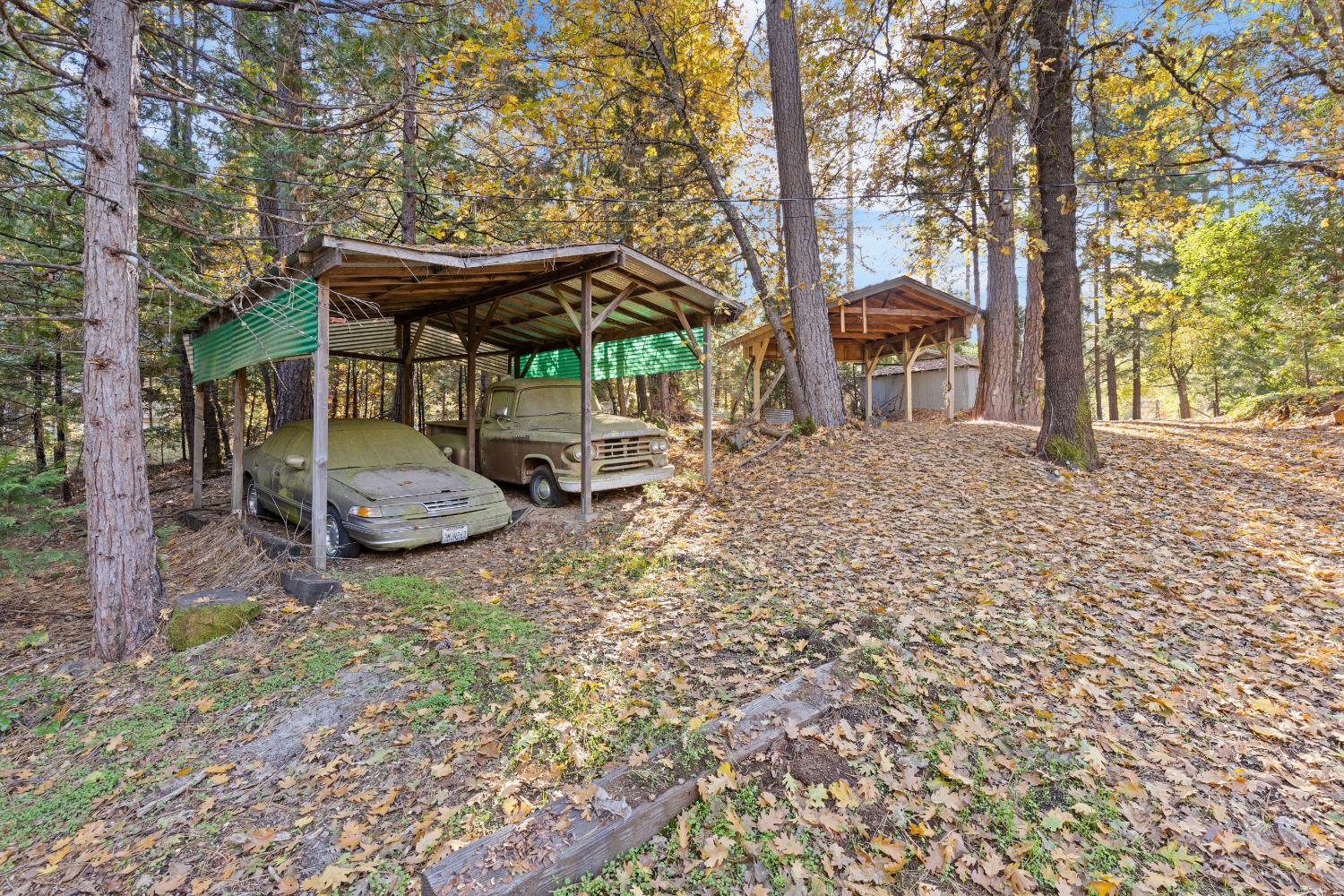13139 North Meadow View Drive Grass Valley, CA 95945 - Photo 53 of 68 a backyard of a house with barbeque oven fire pit table and chairs