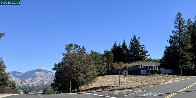 a view of a house with a snow in the background