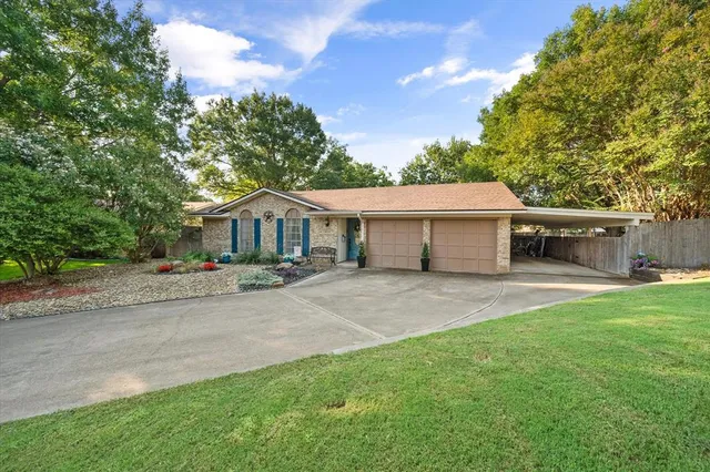 a front view of house with yard and green space