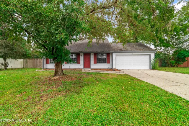 a front view of house with yard and green space