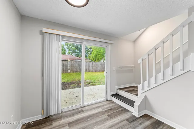 a view of wooden floor and a window in a room