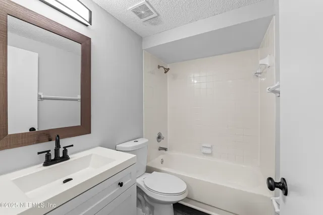a bathroom with a sink toilet tub and shower
