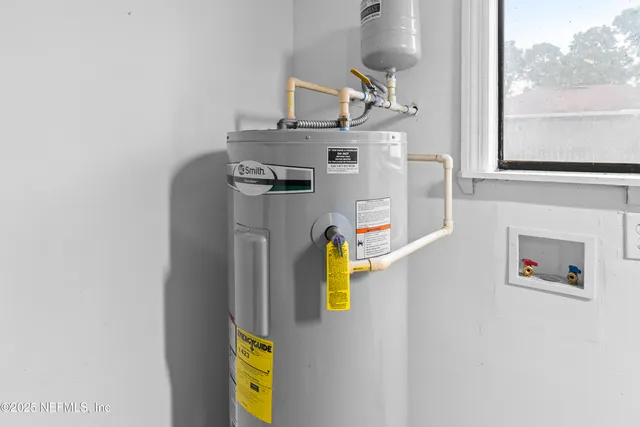 a view of storage and utility room with a window