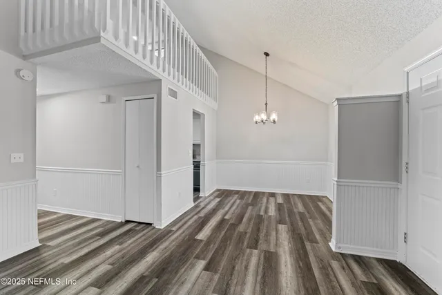 a view of a hallway view with wooden floor and staircase