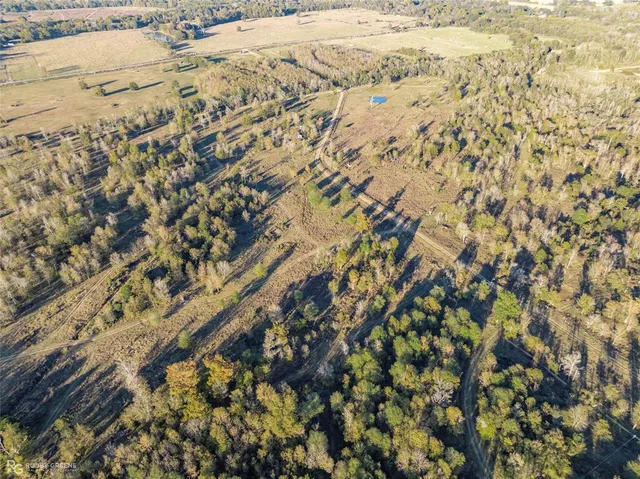 an aerial view of house with yard and mountain view