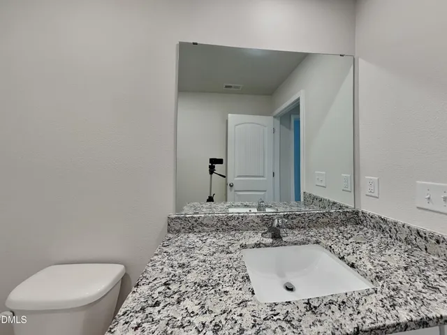 a bathroom with a toilet and a bath tub