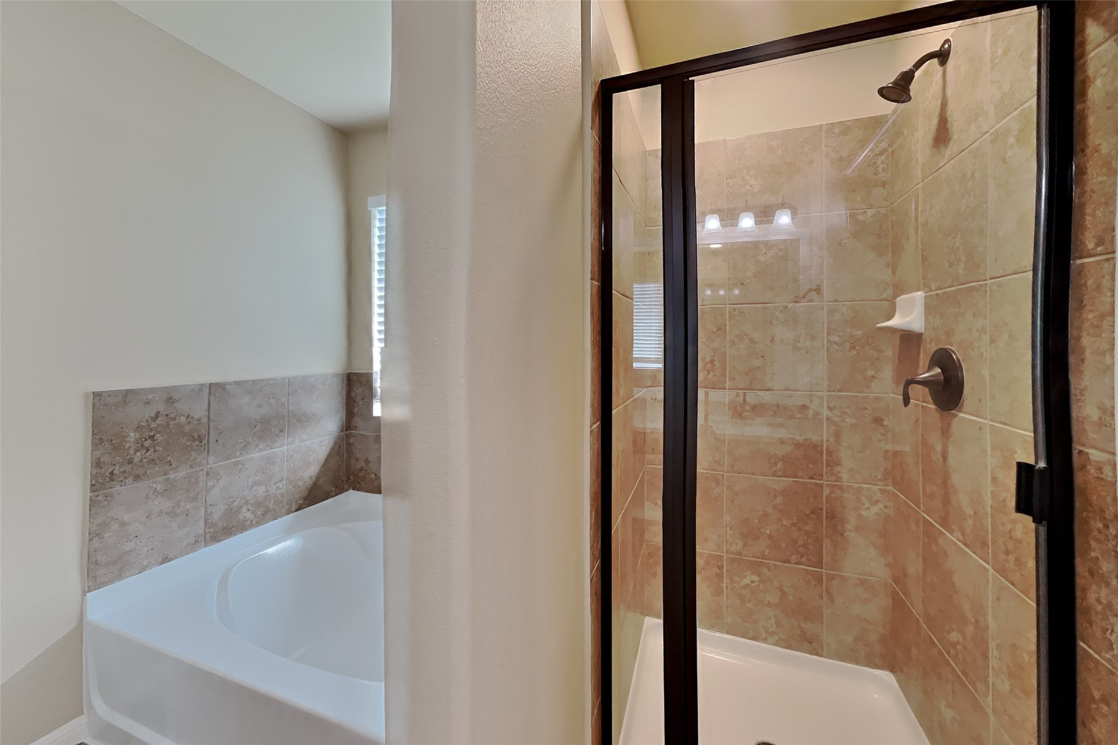 19715 Seabury Path Ct. Katy, TX 77449 - Photo 11 of 20 a bathroom with a glass shower door