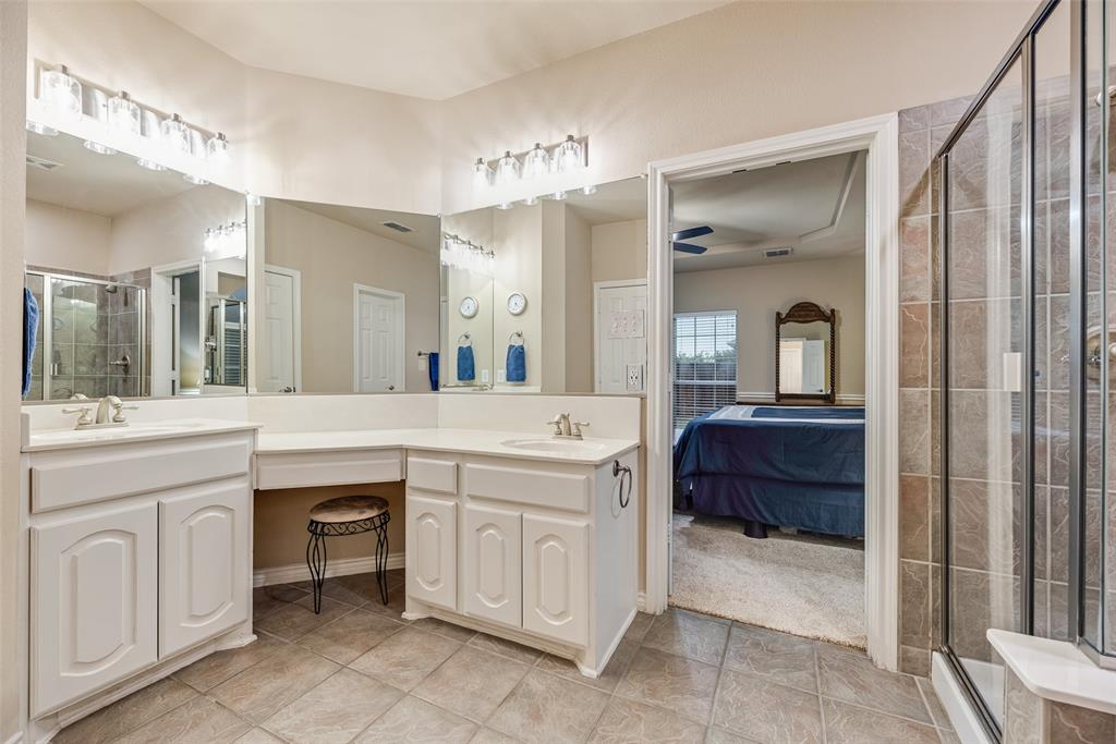 11920 Vienna Apple Road Fort Worth, TX 76244 - Photo 22 of 40 Primary bathroom with ceramic tile floors, separate tub and shower, and walk-in closet at 11920 Vienna Apple in Villages of Woodland Springs community in North Fort Worth